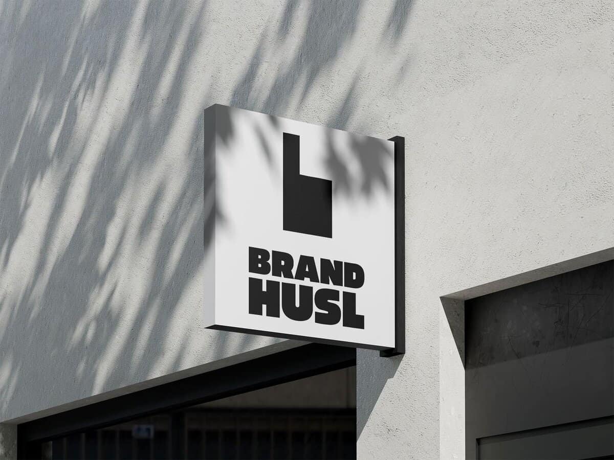 Brand-Husl- a contemporary business sign mounted on a white wall, featuring bold black text and logo, representing a professional brand identity for marketing and branding services.