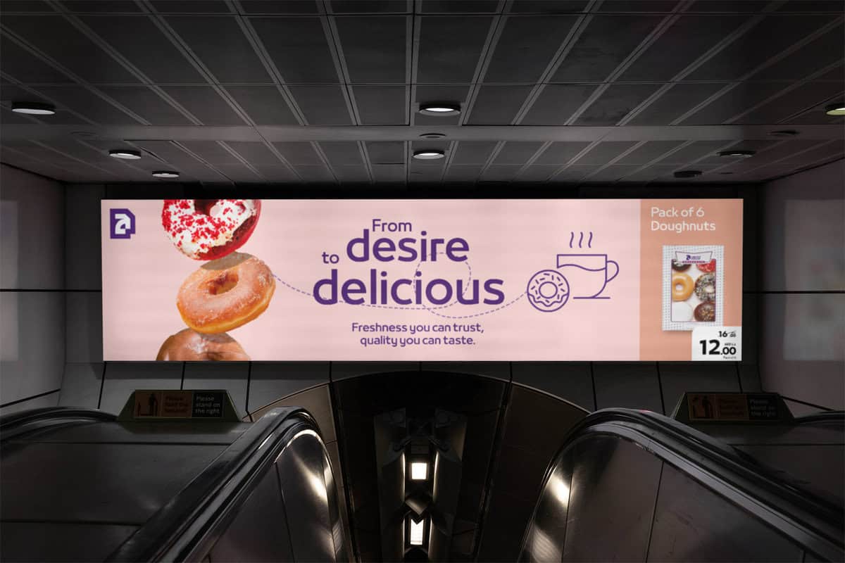 Brand Husl escalator billboard advertising doughnuts in subway station.