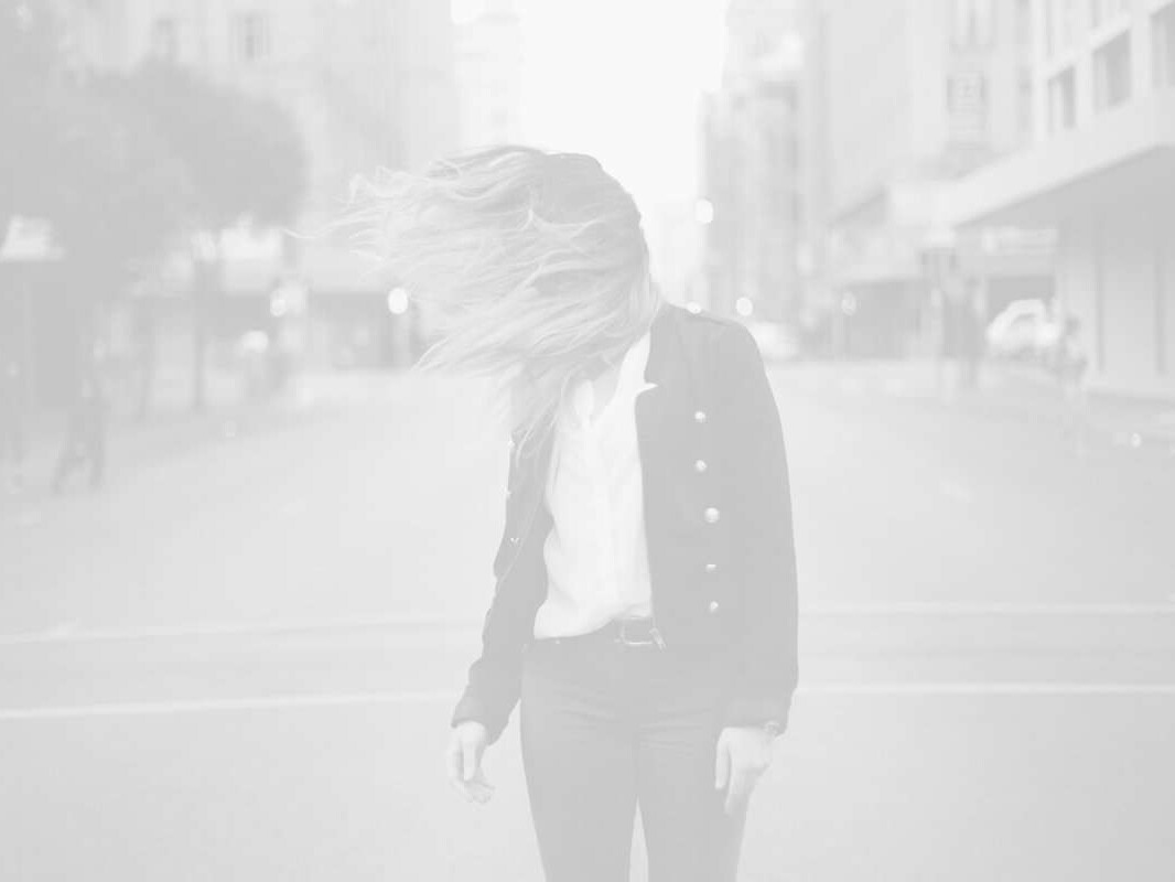 Brand Husl woman with blowing hair on city street